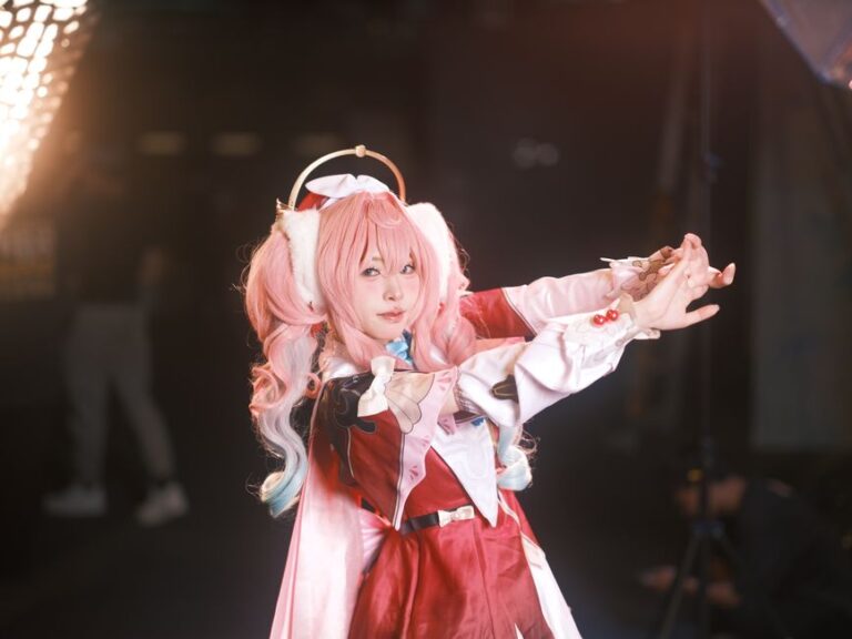 A vivid portrait of an anime cosplay character with pink hair, captured theatrically in Vietnam.