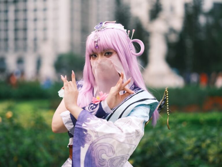 Cosplay enthusiast poses in colorful attire with lavender hair outdoors in Vietnam.