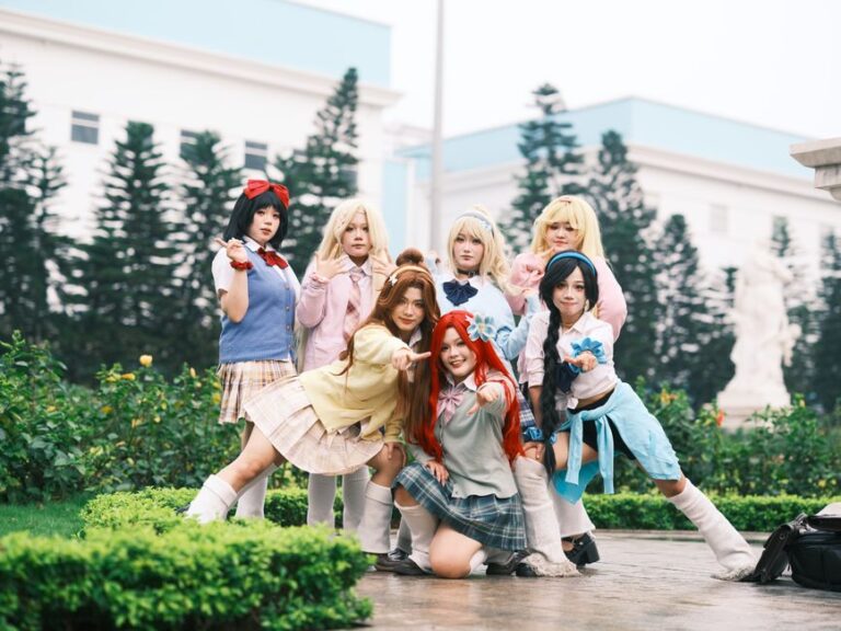 Group of cosplayers in colorful outfits posing outdoors in Vietnam.