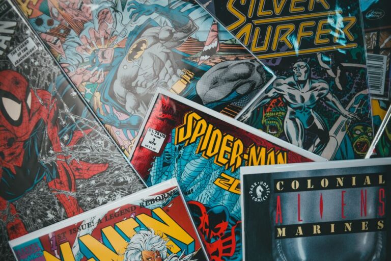 From above closeup of collection of assorted creative comic magazines with colorful illustrations spread out on surface