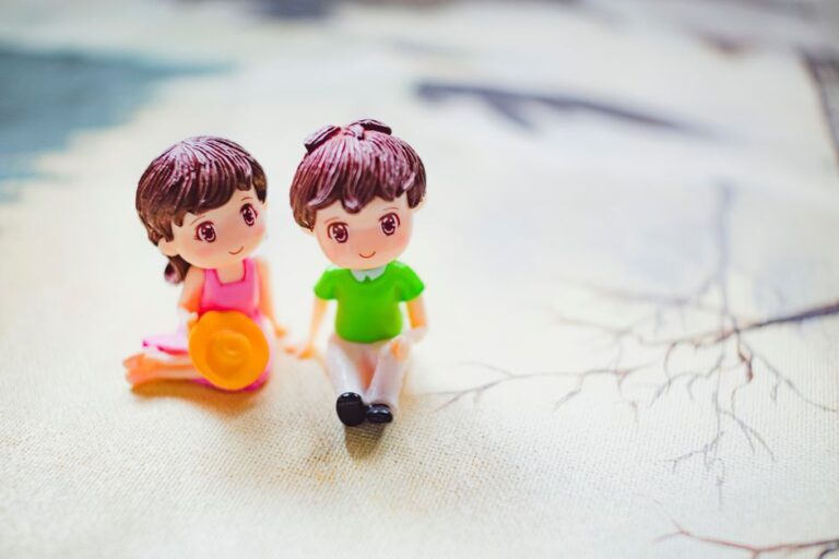 Figures of couple holding hands while sitting on painting of sandy coast on sunny day