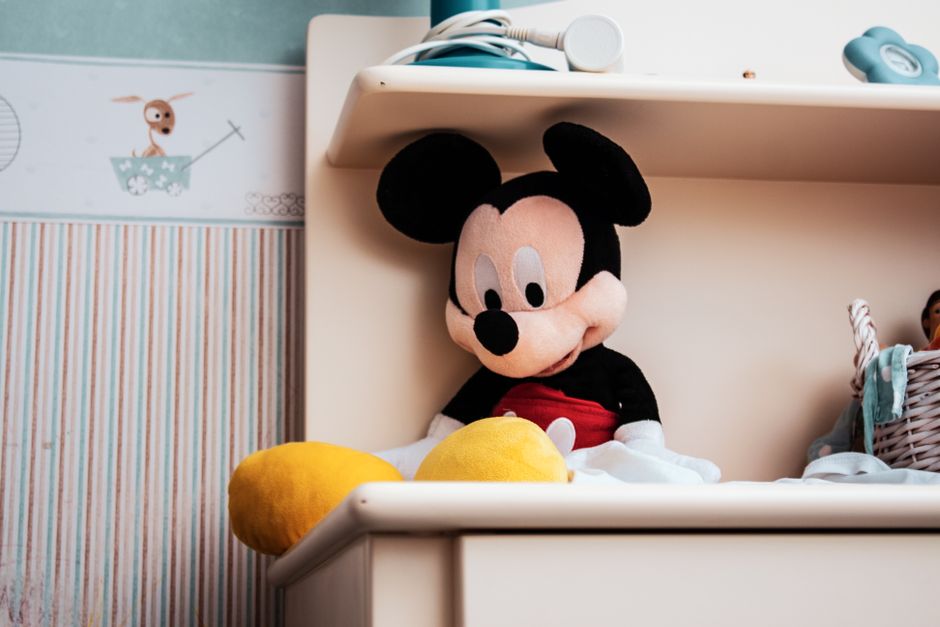Close-up of various cartoon figurines on a modern desk setting, perfect for creativity-themed projects.